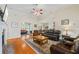 Bright living room with hardwood floors, fireplace, and comfortable leather seating, creating an inviting space at 1524 Guthrie Crossing Dr, Loganville, GA 30052