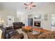 Spacious living room with hardwood floors, fireplace, and leather sofas for relaxing and entertaining at 1524 Guthrie Crossing Dr, Loganville, GA 30052