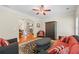 Cozy living room featuring a fireplace, hardwood floors, and comfortable red and black furnishings at 1524 Guthrie Crossing Dr, Loganville, GA 30052