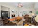Open-concept living room with fireplace, hardwood floors, comfortable seating, and neutral color palette at 1524 Guthrie Crossing Dr, Loganville, GA 30052