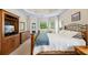 Comfortable carpeted main bedroom boasting an inviting bed, windows, and trey ceilings at 1524 Guthrie Crossing Dr, Loganville, GA 30052