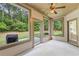 Cozy sunroom with multiple windows offering picturesque backyard views and outdoor access at 1524 Guthrie Crossing Dr, Loganville, GA 30052