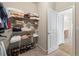 Well-organized walk-in closet featuring shelving, a shoe rack, and an open door to the bathroom at 1524 Guthrie Crossing Dr, Loganville, GA 30052
