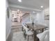 Bright dining area with modern table set, leading to the staircase and kitchen at 1749 Lauranceae Way, Riverdale, GA 30296
