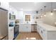 Bright, renovated kitchen with stainless steel appliances, white cabinets, and stone countertops at 1749 Lauranceae Way, Riverdale, GA 30296