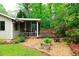 A well-maintained backyard featuring a screened porch, a fire pit, and attractive landscaping at 3402 Wynnewood Ln, Duluth, GA 30096