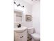 Bright bathroom featuring a classic white vanity, modern black hardware, and framed artwork at 3402 Wynnewood Ln, Duluth, GA 30096