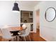 Bright dining room with modern lighting, built-in dry bar and wood floors at 3402 Wynnewood Ln, Duluth, GA 30096