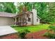 Exterior of a well-kept home with green grass, a paved driveway, and mature landscaping at 3402 Wynnewood Ln, Duluth, GA 30096