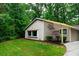 Charming one-story home with a front yard and a newly constructed carport and lush trees at 3402 Wynnewood Ln, Duluth, GA 30096