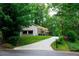 View of the front exterior of the home with an extra long drive way and beautiful mature trees at 3402 Wynnewood Ln, Duluth, GA 30096
