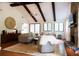 Bright living room with exposed beams, stone fireplace, and ample natural light at 3402 Wynnewood Ln, Duluth, GA 30096
