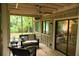 Cozy screened porch with wicker seating, natural light, and a tranquil view of the backyard at 3402 Wynnewood Ln, Duluth, GA 30096