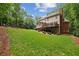 Expansive backyard showcasing lush greenery and the home's deck at 770 Spalding Heights Dr, Atlanta, GA 30350