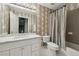 Well-lit bathroom featuring stylish mirror, modern fixtures, and a shower-tub combination at 770 Spalding Heights Dr, Atlanta, GA 30350