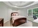 Cozy bedroom features a comfortable bed, natural light from the window, and neutral decor at 770 Spalding Heights Dr, Atlanta, GA 30350
