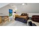 Dormer bedroom featuring a desk, a queen bed, a ceiling fan, and ample natural light at 770 Spalding Heights Dr, Atlanta, GA 30350