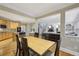 Open-concept kitchen and dining area with hardwood floors that flows into a cozy living space with fireplace and staircase at 770 Spalding Heights Dr, Atlanta, GA 30350
