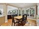 Inviting dining room with hardwood floors, large windows, and an adjacent living space, perfect for Gathering gatherings at 770 Spalding Heights Dr, Atlanta, GA 30350
