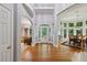 Grand foyer with hardwood floors, soaring ceilings, and an open floor plan leading to the dining and living spaces at 770 Spalding Heights Dr, Atlanta, GA 30350