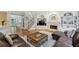 Open living room flowing into foyer with fireplace, built-in cabinets and plush sofas for comfortable gatherings at 770 Spalding Heights Dr, Atlanta, GA 30350
