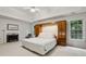 Spacious main bedroom with a fireplace, tray ceiling, and built-in storage, offering a luxurious retreat at 770 Spalding Heights Dr, Atlanta, GA 30350