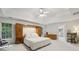 Bright and airy main bedroom featuring a tray ceiling, built-in storage, and natural light from large windows at 770 Spalding Heights Dr, Atlanta, GA 30350