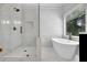 Luxurious bathroom with marble tile, glass shower, soaking tub, and gold fixtures near the window at 140 Ashewoode Downs Ln, Johns Creek, GA 30005