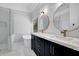 Modern bathroom with double sinks, marble countertops, gold fixtures, and a soaking tub at 140 Ashewoode Downs Ln, Johns Creek, GA 30005