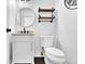 Modern powder room with white vanity, round mirror, floating shelves, and a sleek toilet at 140 Ashewoode Downs Ln, Johns Creek, GA 30005