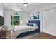 This bedroom boasts a large window, closet, and soft carpet at 140 Ashewoode Downs Ln, Johns Creek, GA 30005