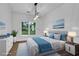 Nicely staged bedroom with large window, white walls, light grey headboard and white dresser at 140 Ashewoode Downs Ln, Johns Creek, GA 30005