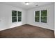 This cozy bedroom features ample sunlight from the large windows at 140 Ashewoode Downs Ln, Johns Creek, GA 30005