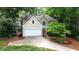 Charming two-story home with well-manicured landscaping and an attached two-car garage at 140 Ashewoode Downs Ln, Johns Creek, GA 30005
