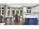 Bright kitchen with stainless steel appliances, a blue island, hardwood floors, and breakfast table at 140 Ashewoode Downs Ln, Johns Creek, GA 30005