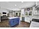 Open-concept kitchen featuring a blue island, stainless steel appliances, and hardwood floors at 140 Ashewoode Downs Ln, Johns Creek, GA 30005