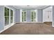 Spacious living room with multiple windows offering natural light and neutral-colored walls at 140 Ashewoode Downs Ln, Johns Creek, GA 30005