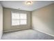 This cozy bedroom features plush carpet, neutral paint and a window for natural light at 1643 Jackson Nw Way, Atlanta, GA 30318