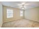 Bedroom featuring beige carpet, neutral walls, many windows, and a ceiling fan at 1643 Jackson Nw Way, Atlanta, GA 30318