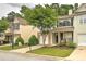 Charming townhome with a manicured lawn and a quaint front porch seating area at 1643 Jackson Nw Way, Atlanta, GA 30318