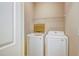 Practical laundry room with white washer and dryer, wire shelving, and neutral walls at 1643 Jackson Nw Way, Atlanta, GA 30318