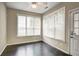 Cozy sun room featuring dark hardwood floors, many windows, and neutral walls and ceiling fan at 1643 Jackson Nw Way, Atlanta, GA 30318