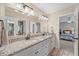 Bathroom with a double sink vanity, granite countertops, and white cabinets at 390 Wilde Green Dr, Roswell, GA 30075