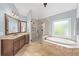 Bathroom showcasing a soaking tub, walk-in shower, and vanity with stone countertop at 390 Wilde Green Dr, Roswell, GA 30075