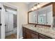 Bathroom vanity with a stone countertop, and a tub/shower with white curtain at 390 Wilde Green Dr, Roswell, GA 30075