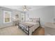 Bedroom with neutral decor, natural light, and a comfortable bed and desk area at 390 Wilde Green Dr, Roswell, GA 30075