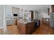 Open concept kitchen with stainless appliances, granite countertops, and hardwood floors at 390 Wilde Green Dr, Roswell, GA 30075