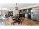 Kitchenette featuring stainless steel appliances, dark cabinets, and an adjacent sitting area at 390 Wilde Green Dr, Roswell, GA 30075