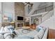 Cozy living room with stone fireplace, high ceilings, and ample natural light at 390 Wilde Green Dr, Roswell, GA 30075