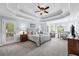 Main bedroom with tray ceiling, sitting area, and access to a private balcony at 390 Wilde Green Dr, Roswell, GA 30075